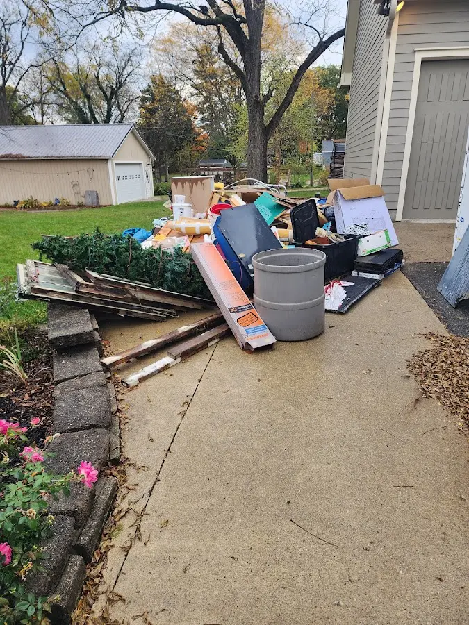 Dumpster being loaded with debris for 12 Yard Dumpster Rental in Colesville